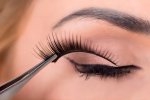 What is the trick to putting on false eyelashes?